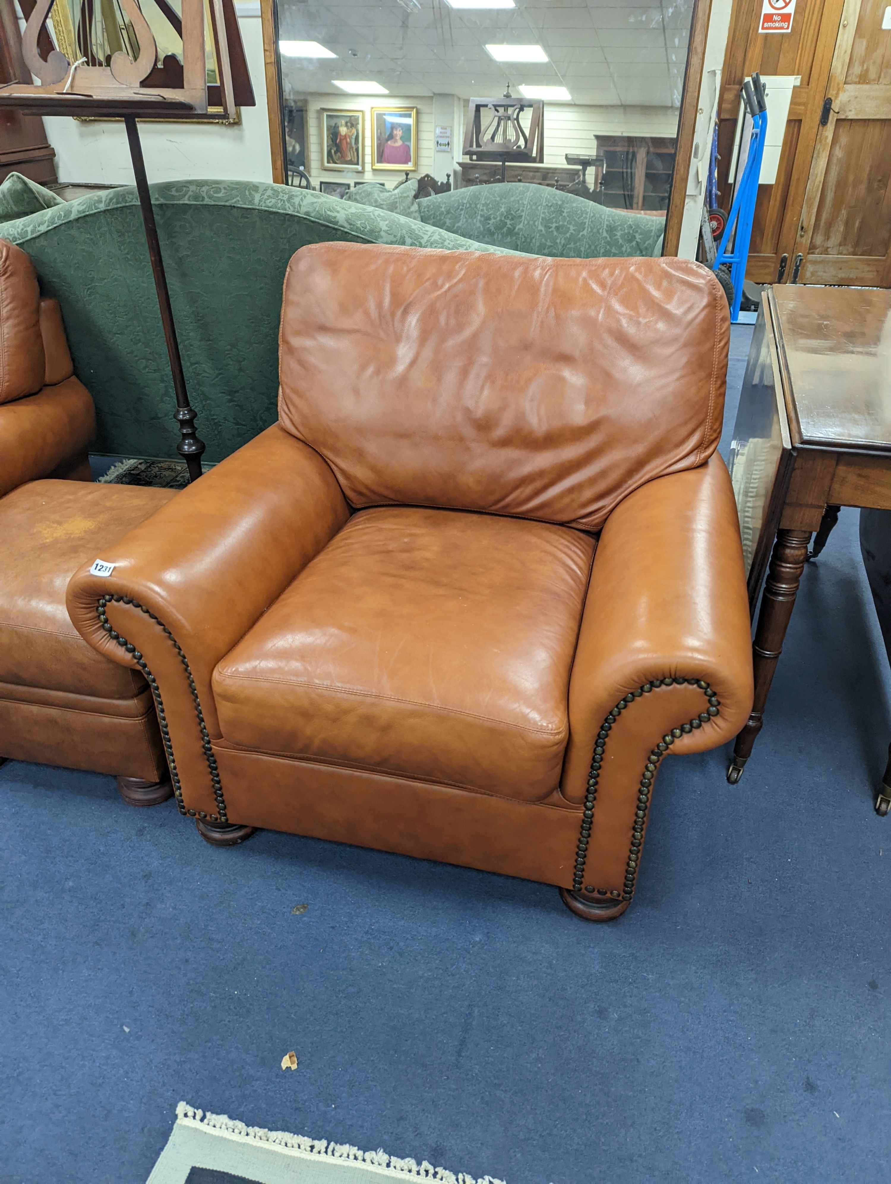 A contemporary tan leather three piece suite and footstool, settee length 150cm, depth 90cm, height 84cm
